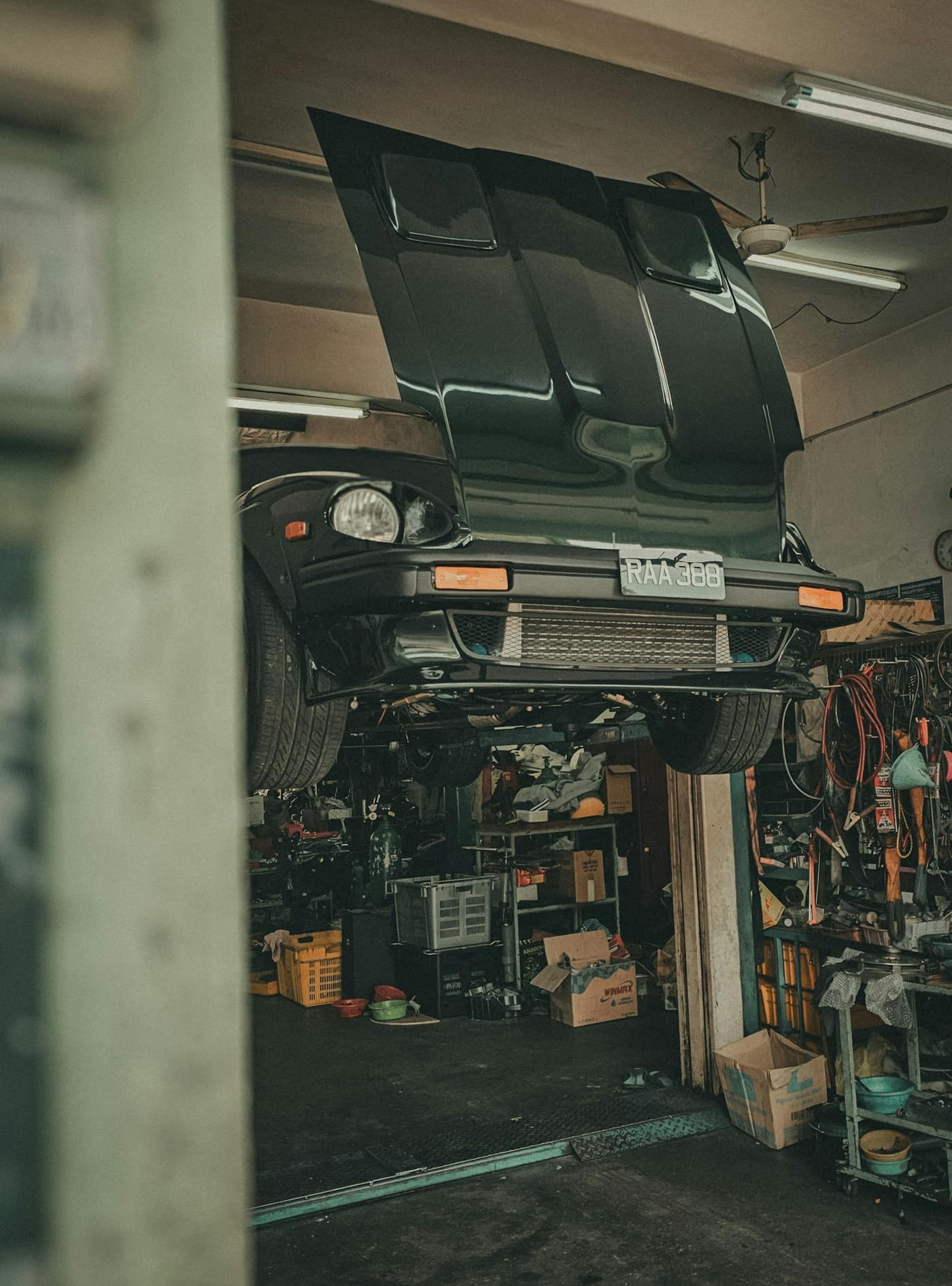 A car on a lift in an auto repair shop