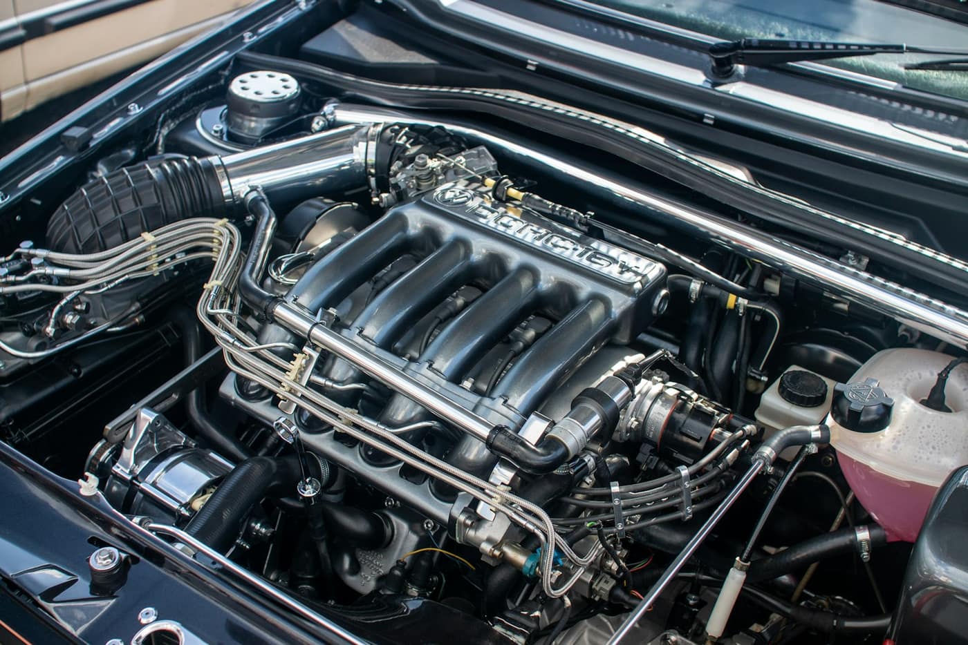 A car engine compartment with the hood up