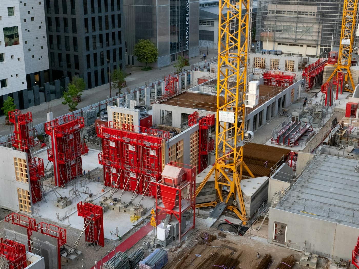 A construction site with a tower crane against the sky