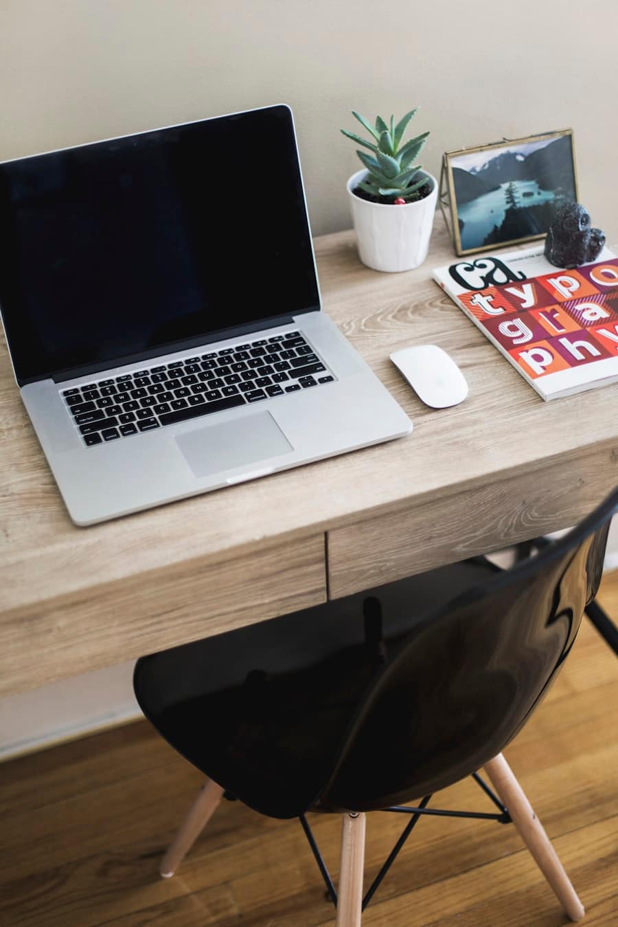 A clean consultant-style laptop and desk setup