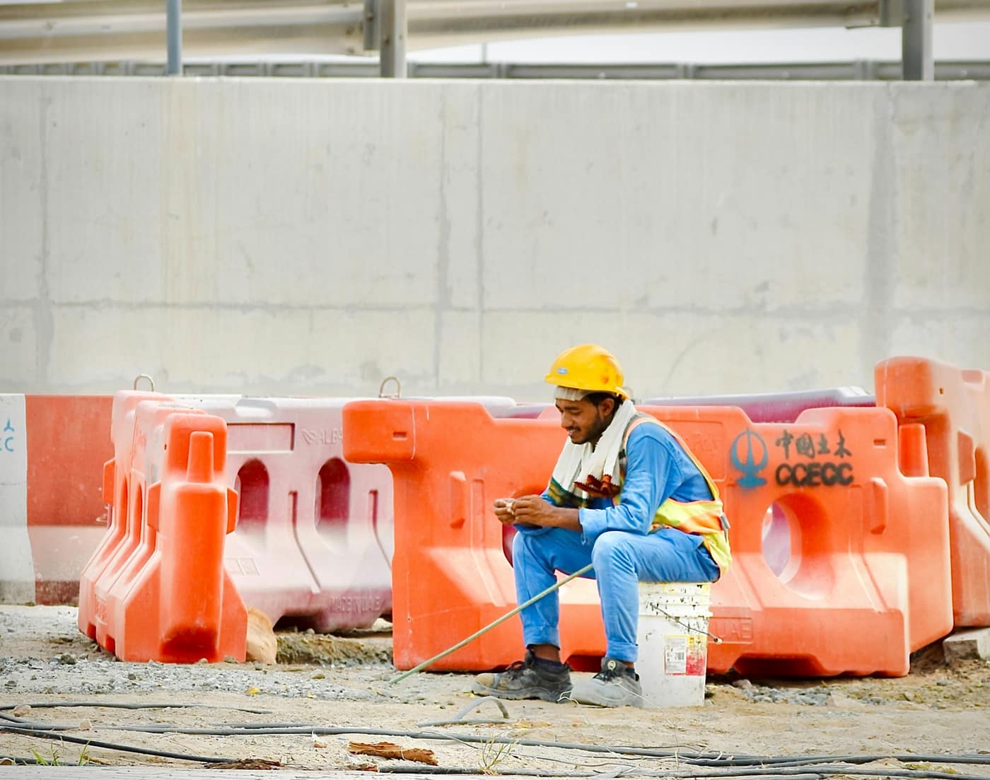 A construction worker in a hard hat taking a break on site