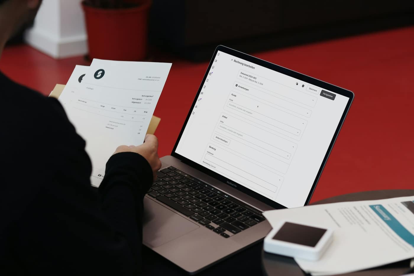 Paperwork and a laptop on a desk