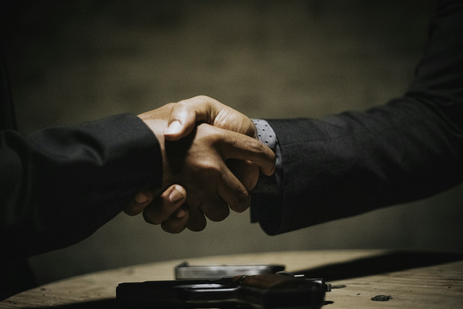 A handshake over a desk agreeing a deposit