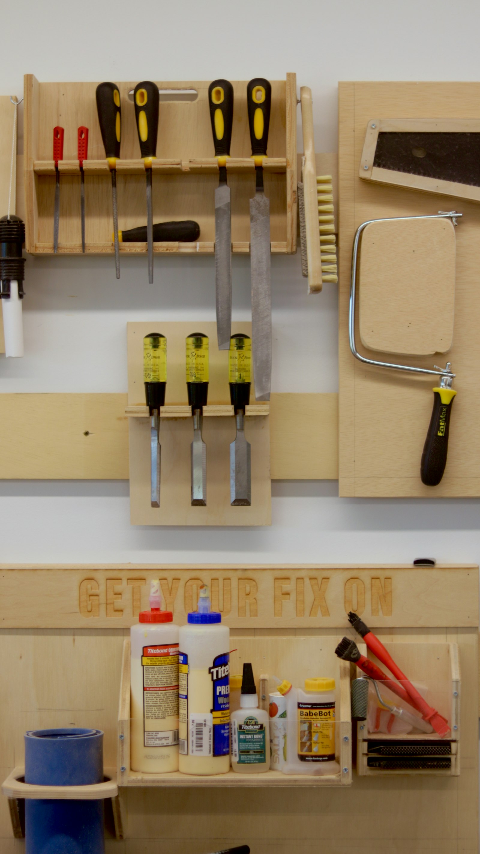 A handyman's tool belt and tools on a workbench