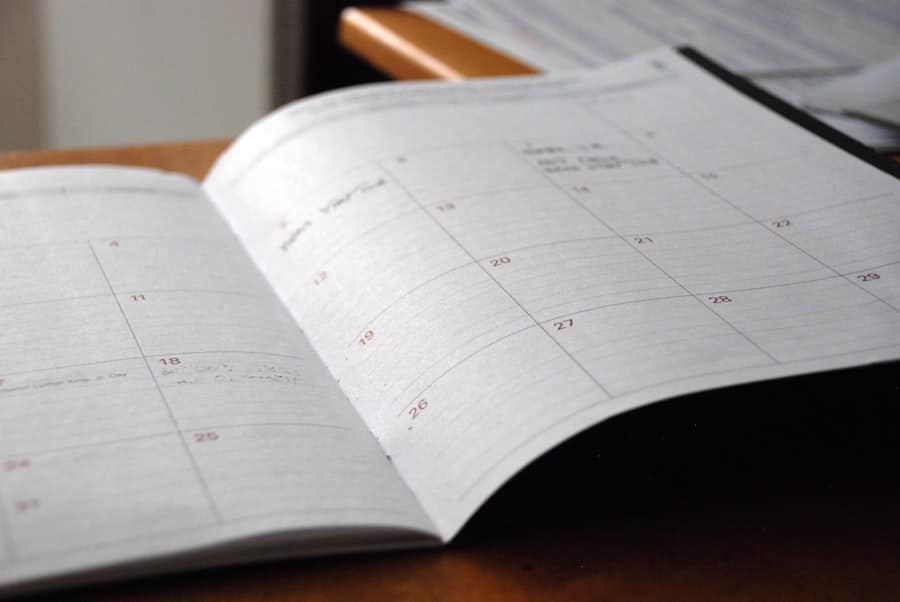 An open monthly planner on a wooden desk
