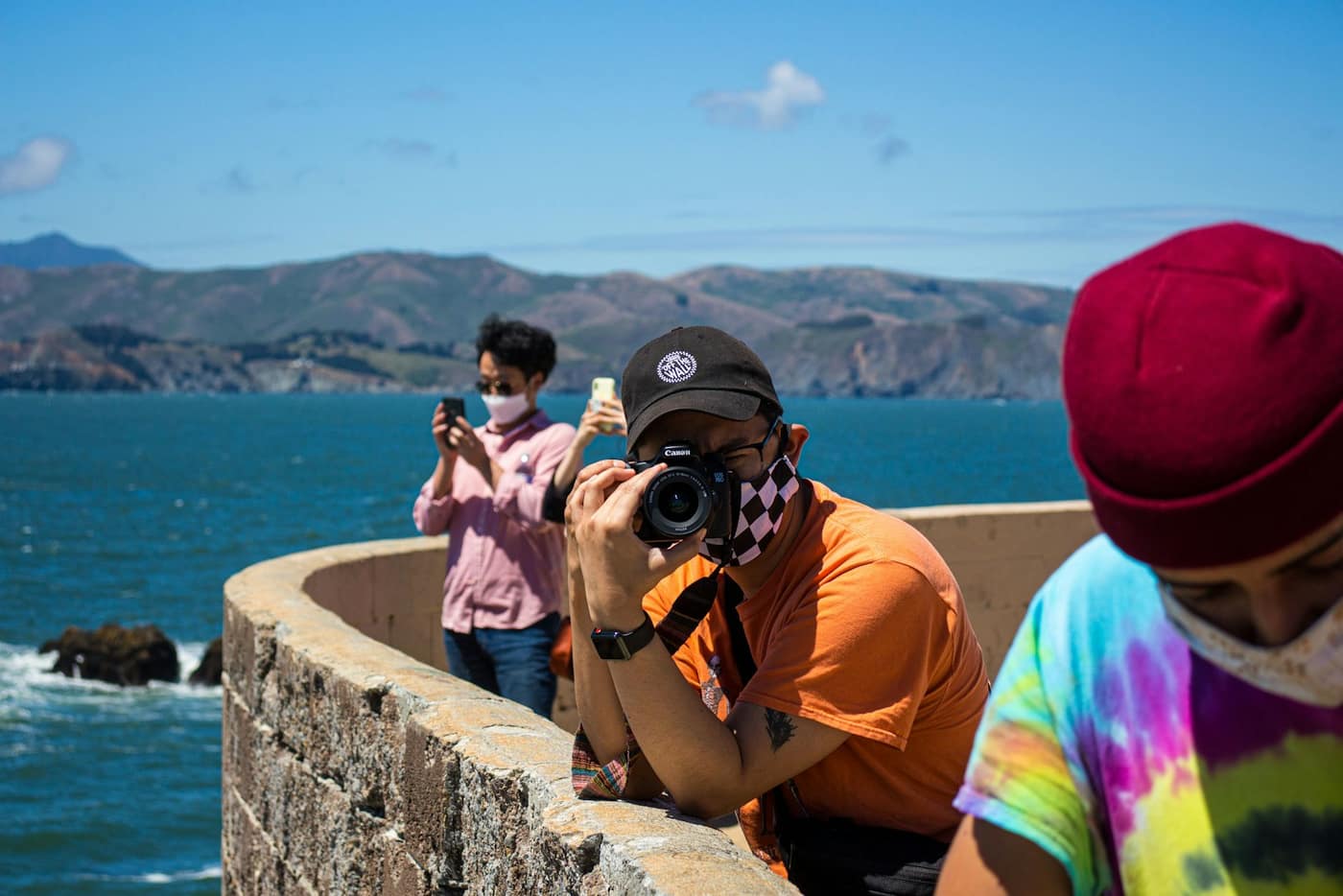 A photographer holding a DSLR camera