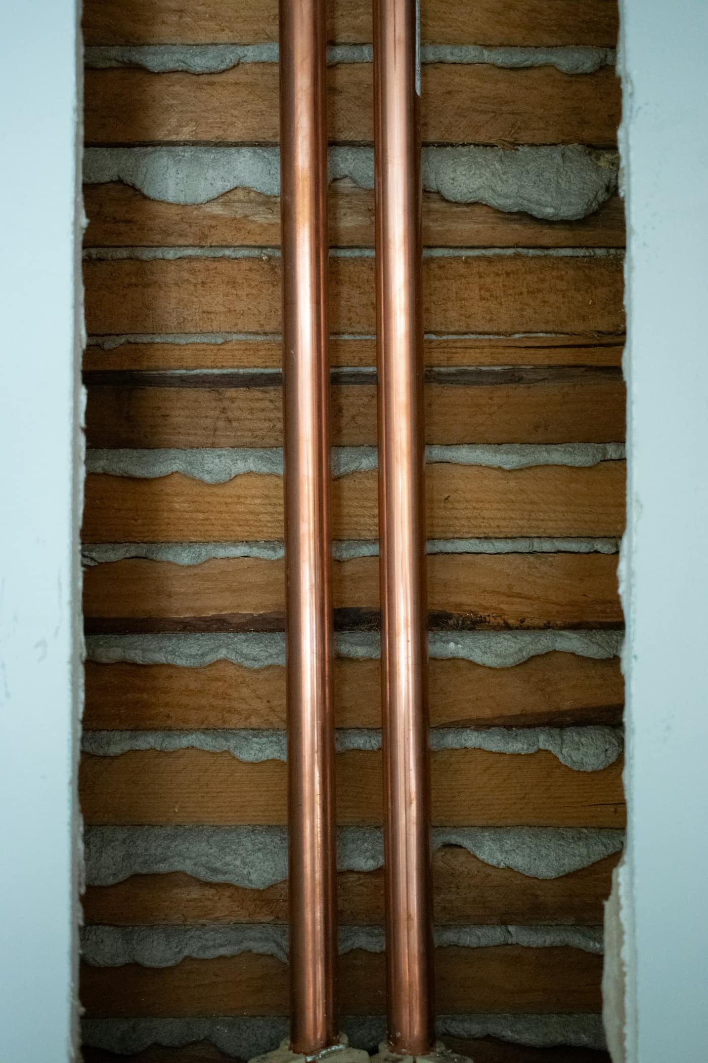 Copper plumbing pipes installed along a wall