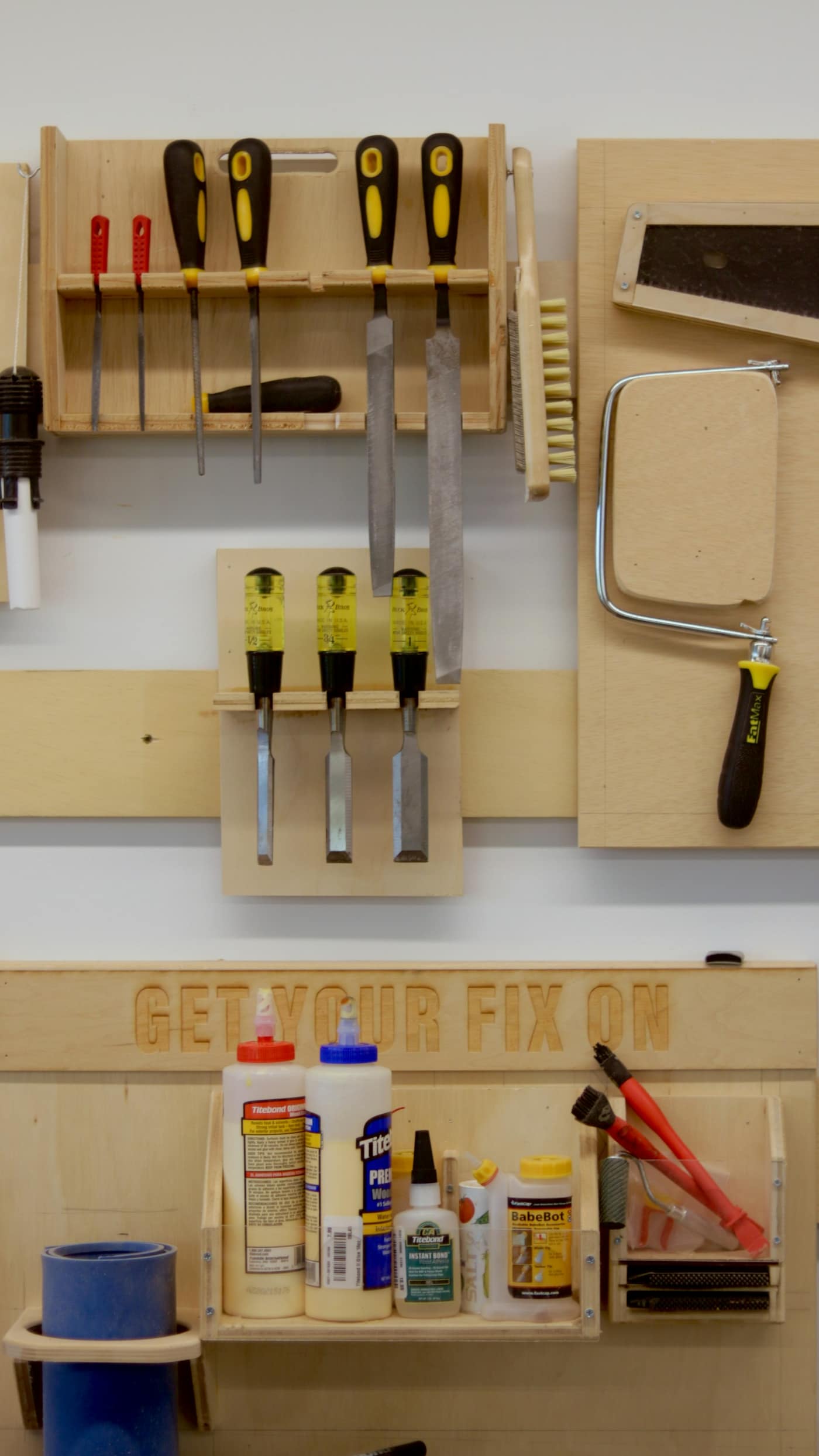 A workbench with plumbing and hand tools