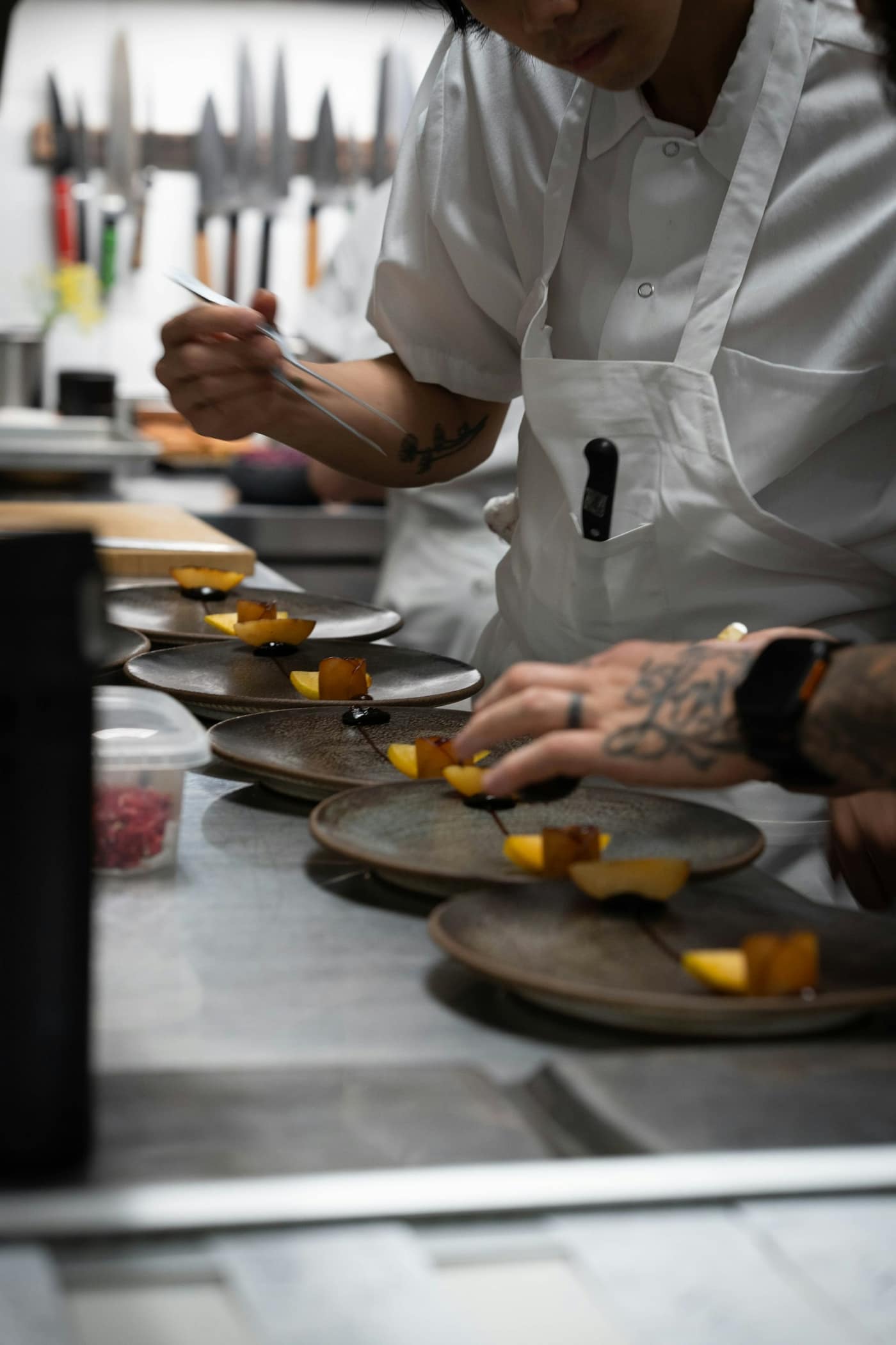 A restaurant kitchen with a chef plating food