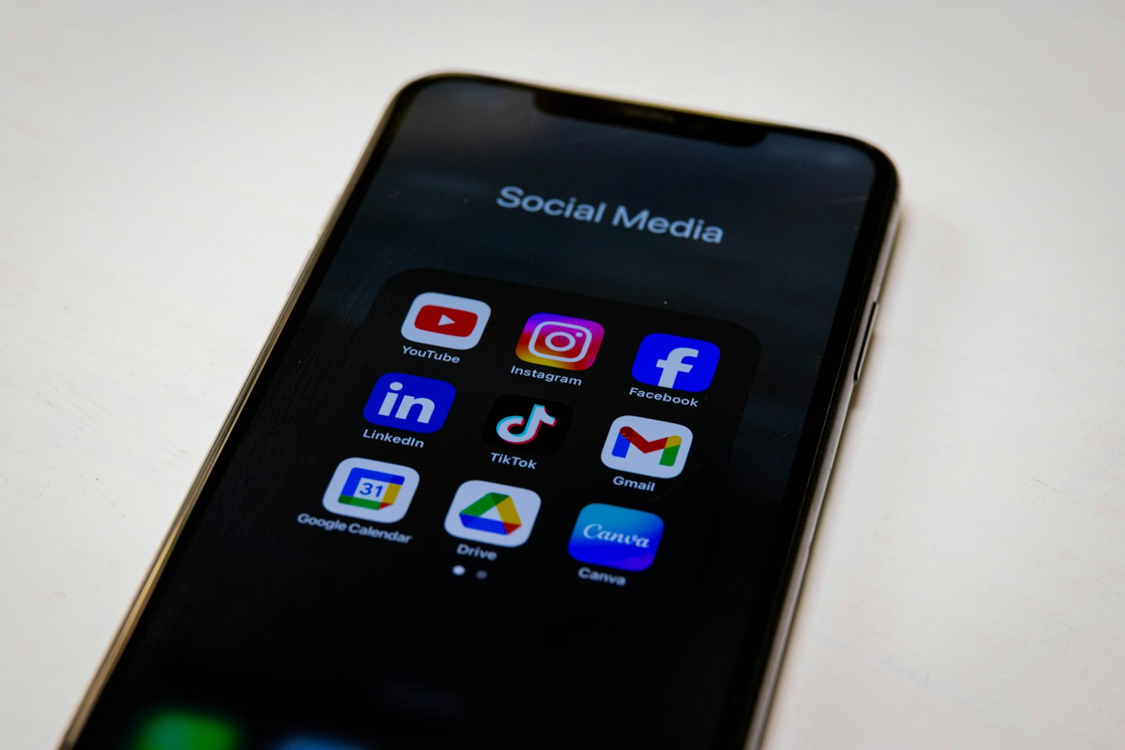 A phone showing social media apps on a desk