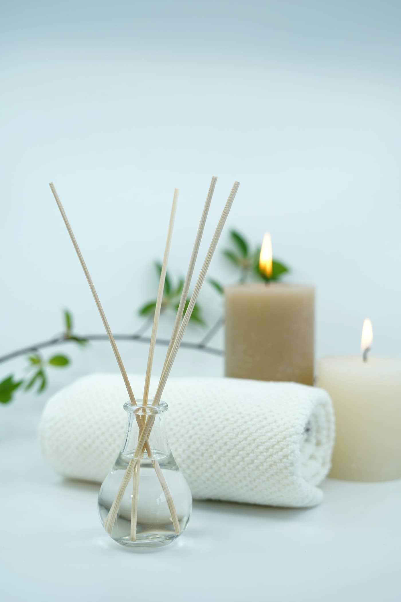 A spa setup with candles, towels, and a diffuser